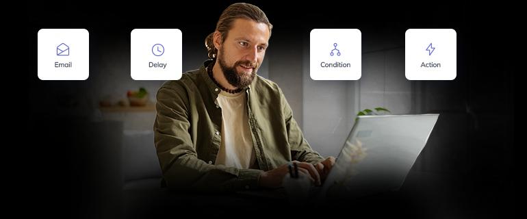 A man discovering email automation capabilities on a laptop