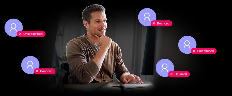 A man working at a laptop, looking at Suppressions in Elastic Email app